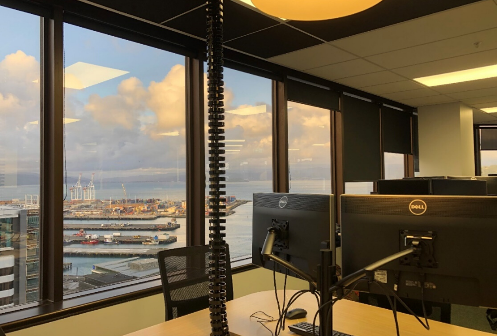 Michelle arrives at the office and chooses a desk by the window