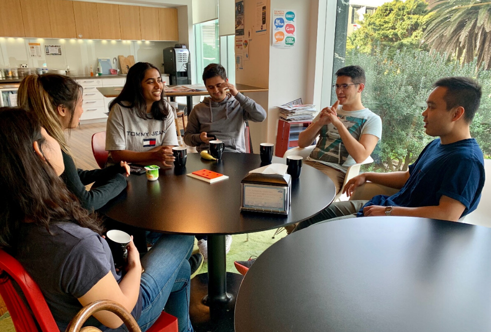 The graduates catching up over a quick coffee on a casual Friday morning.