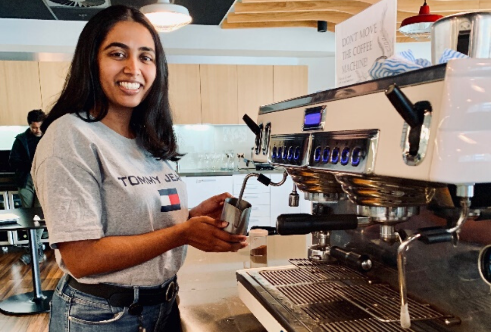 Richelle getting coffee or hot chocolate in the kitchen