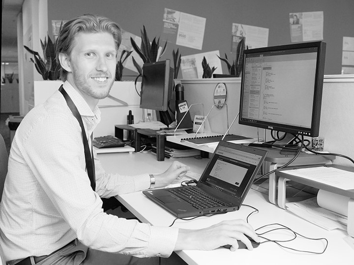 DXC Graduate Chris Gordon at his desk