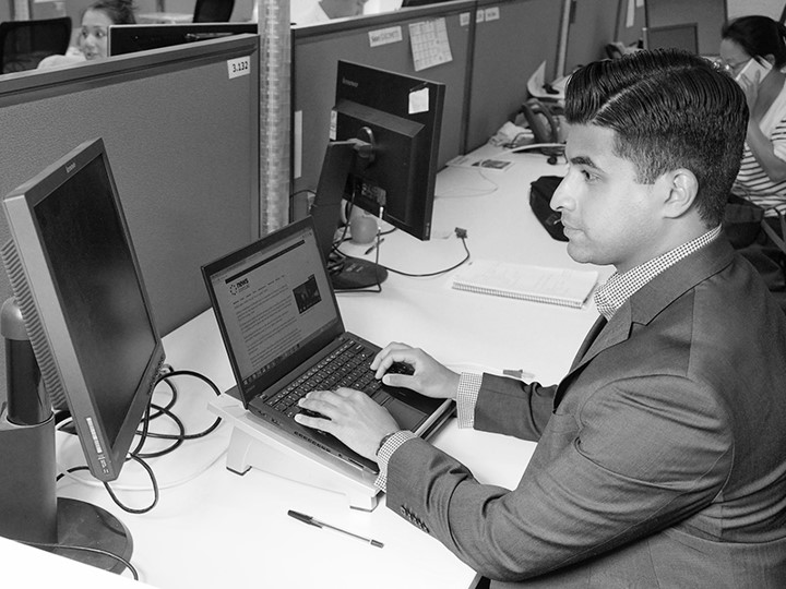 Jithin Xavier DXC Graduate on his desk in front of a computer
