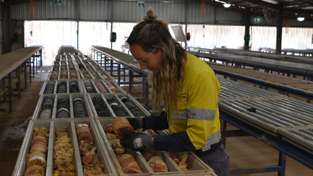 Newmont Graduate Courtney Anders with trays of drill core