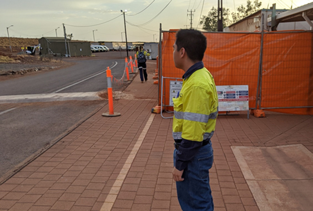Newmont Goldcorp graduate Lawrence Alago waiting for the bus