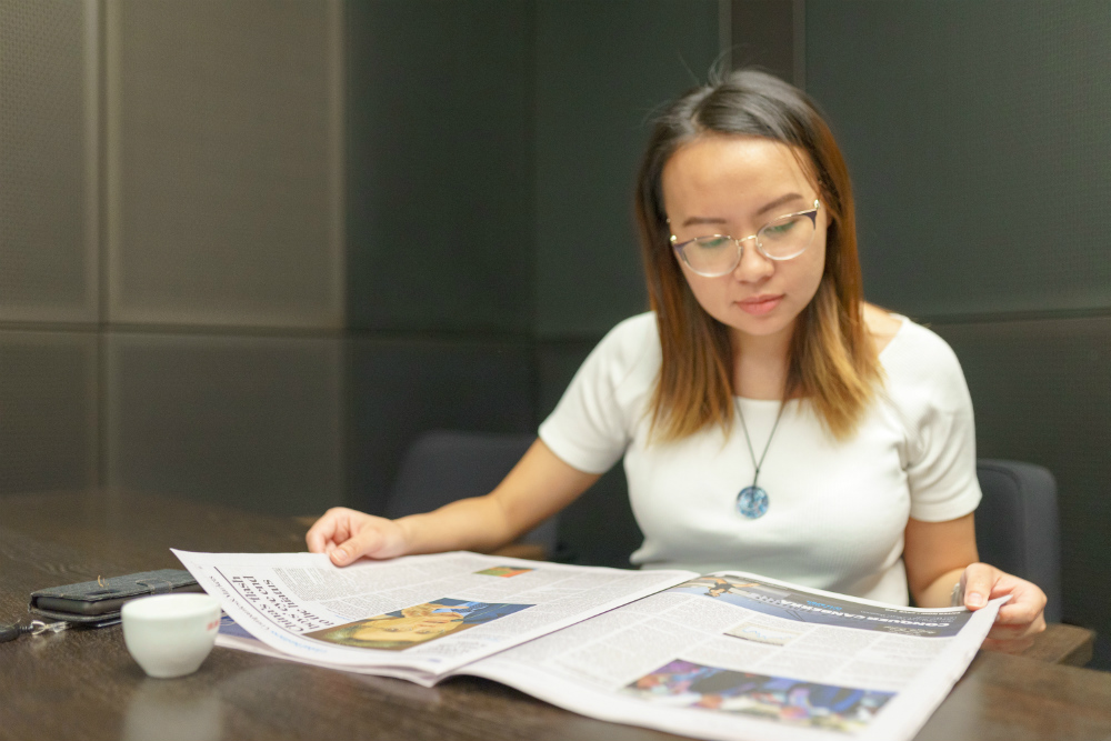 TAL Australia Sarah Khoo reading newspaper