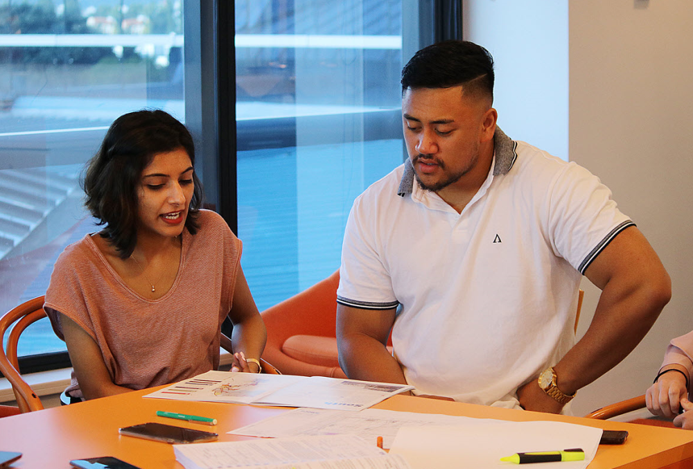 Beca Graduate- A male and female professional discussing about their projects.