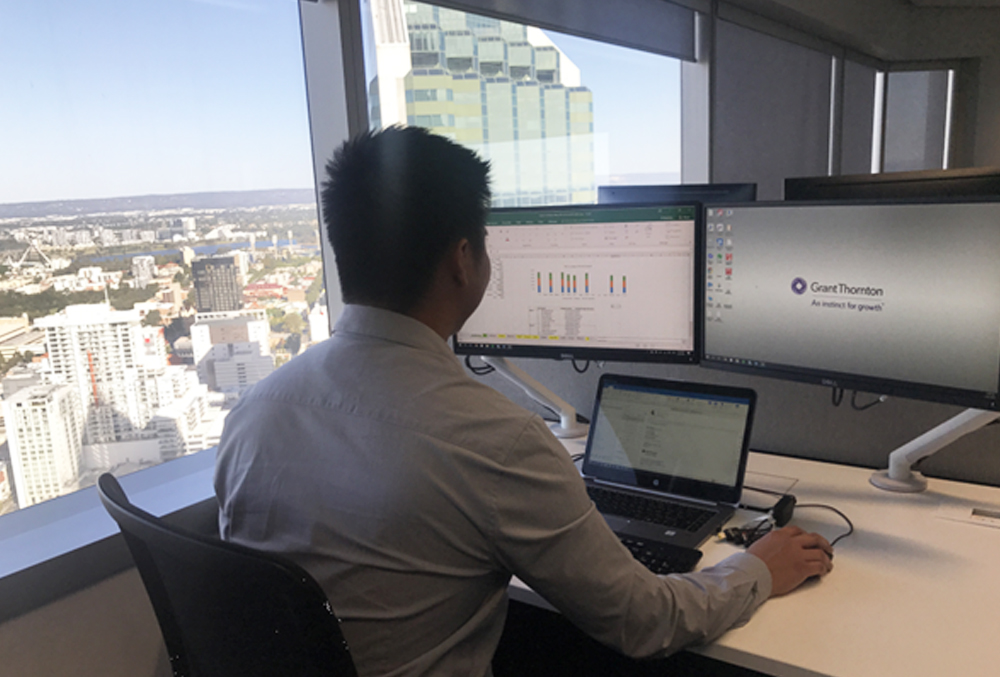 Grant Thornton Graduate Al Bautista at his desk