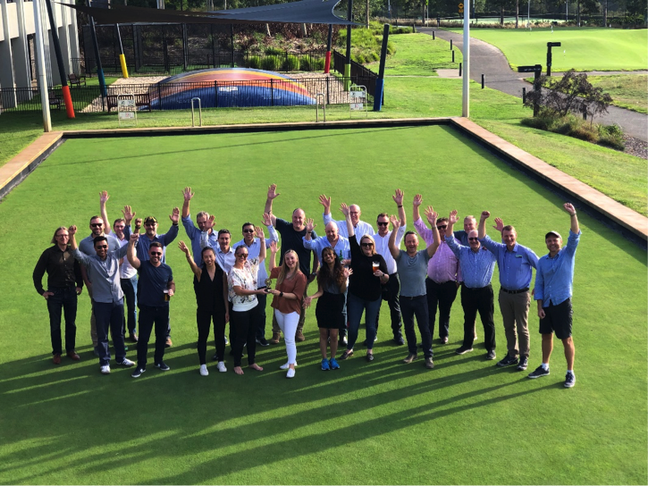 Group of professionals waving at the camera