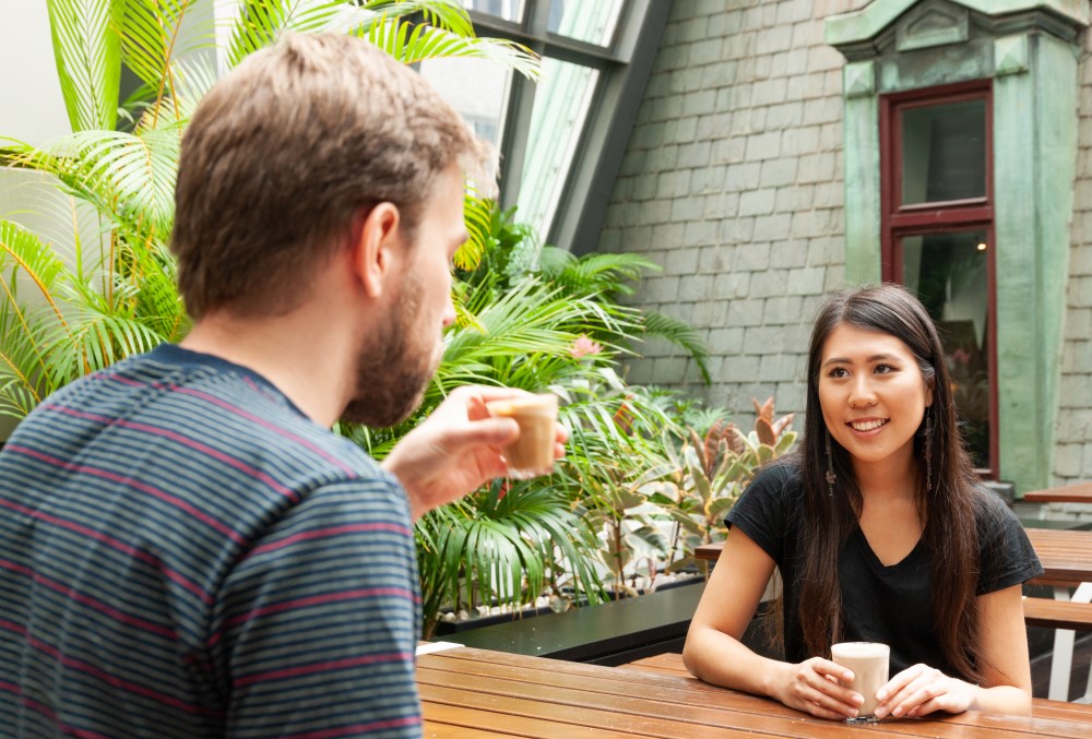 Optiver Graduate- A young female professional having coffee with her colleague.