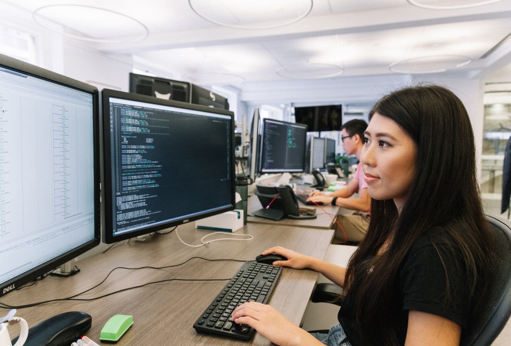 Optiver Graduate- A young female professional working on her computer.