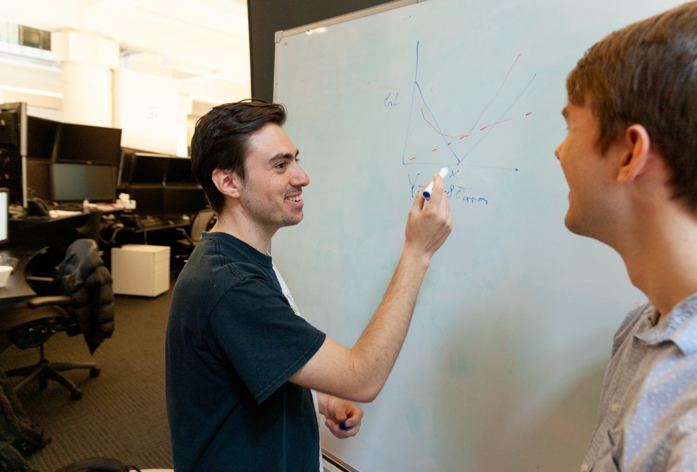 Optiver Graduate- A young male professional having a business meeting with his team.