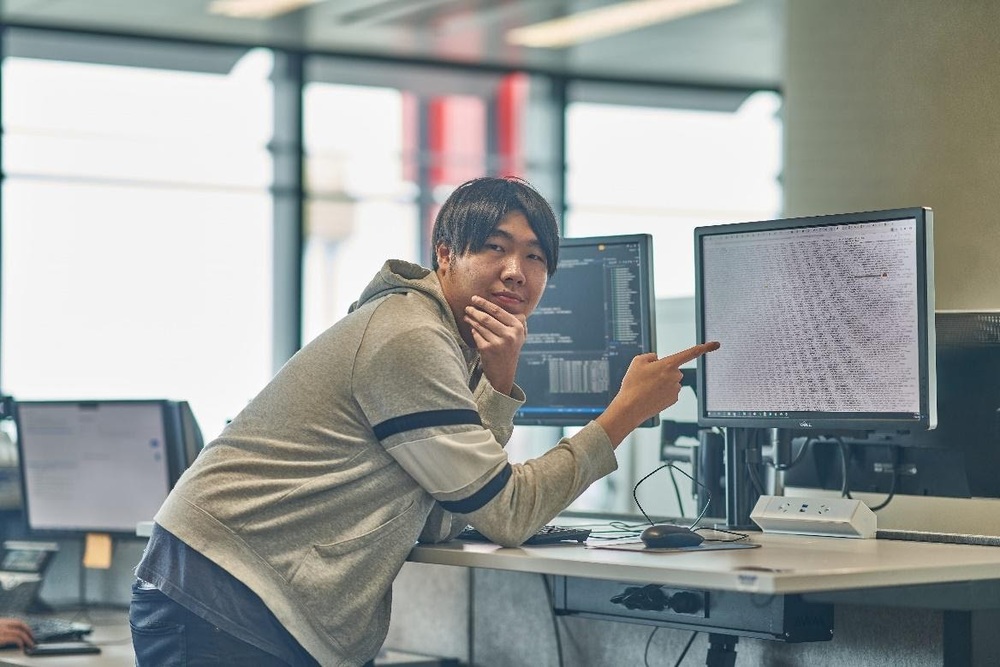 A young professional at his office desk