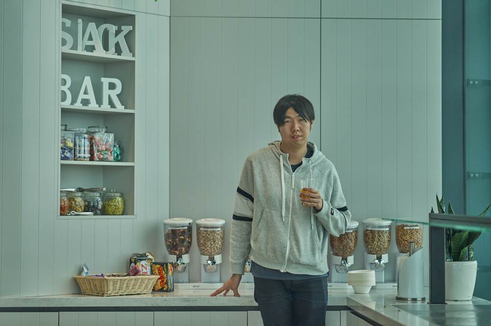 A young professional at the office kitchen