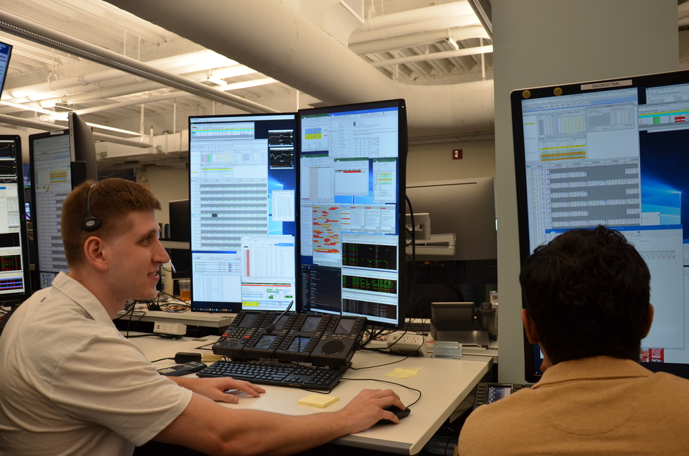 Two young professionals at their office desks
