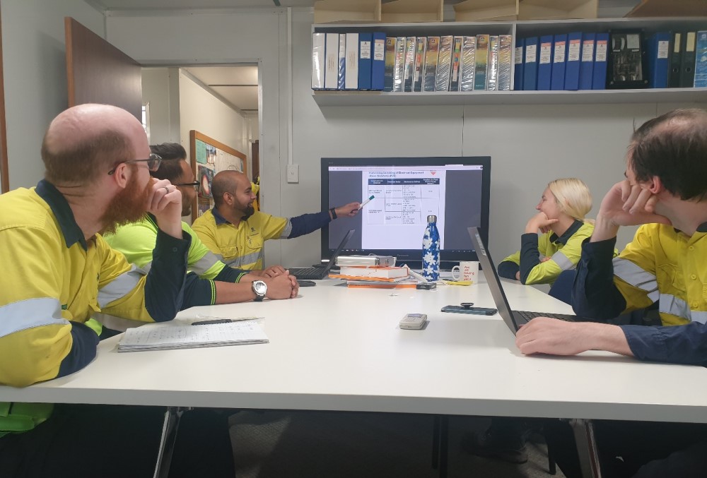 Alcoa of Australia Graduate - Young female professional having meeting with her colleagues.