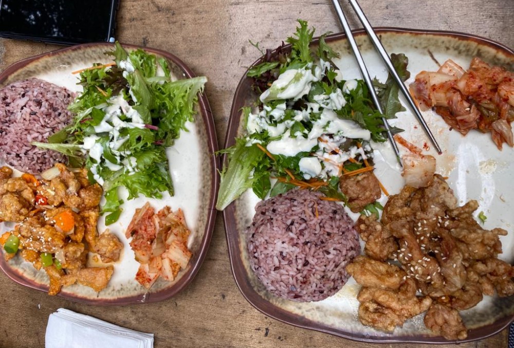 Capgemini Australia Graduate - Two plates of rice, meat, and vegetables