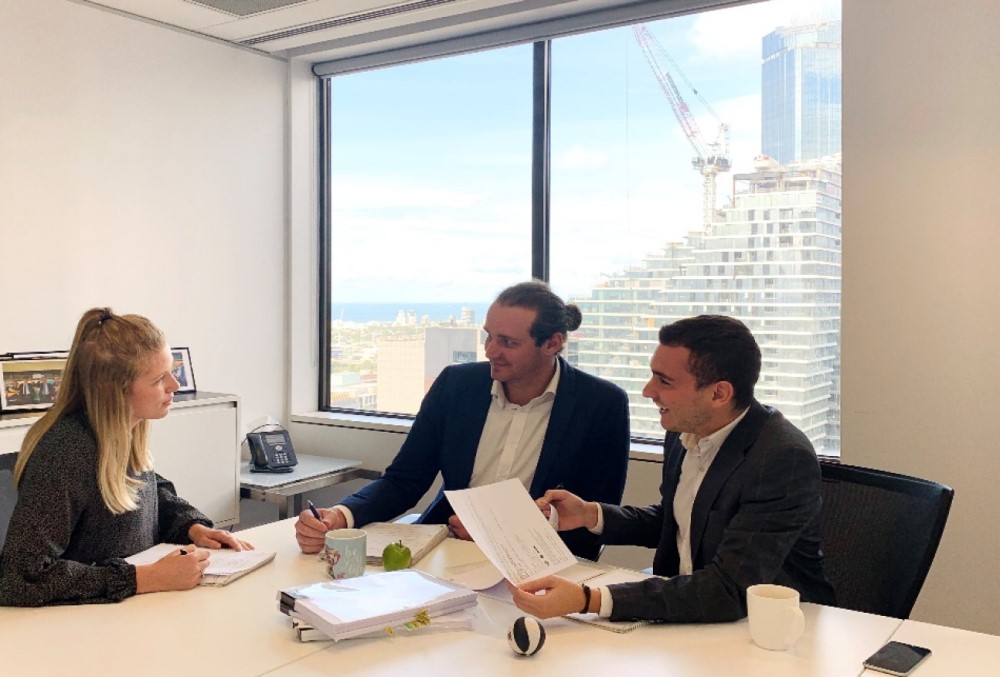 Cor cordis Graduate- Three accountants conducting a meeting.