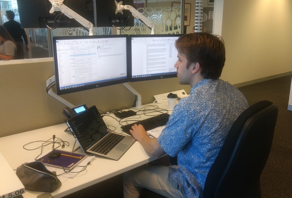 Department of Agriculture, Water and the Environment Graduate - Young male professional sitting on his desk