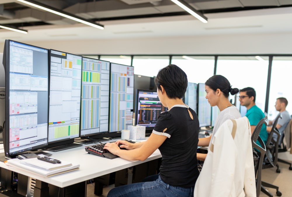 Exponential Trading Graduate- Traders working on their desks.