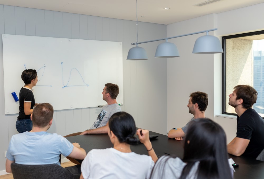 Exponential Trading Graduate- Traders having their progress meeting.