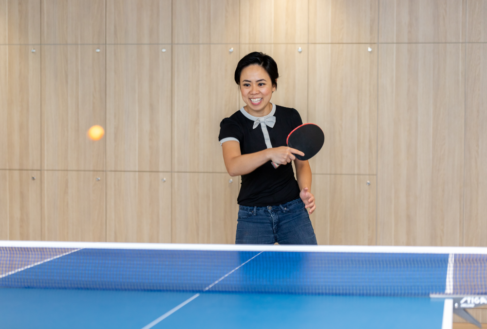 Exponential Trading Graduate- Young lady playing table tennis.