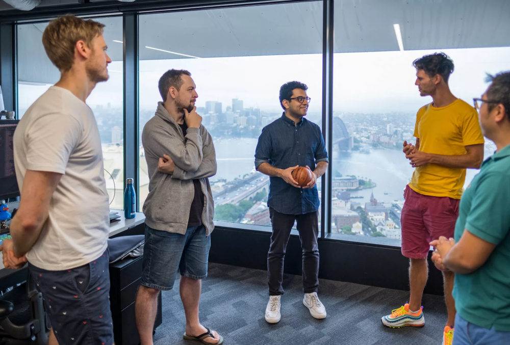 IMC Graduate- Male professional talking with his colleagues about potential new ideas.