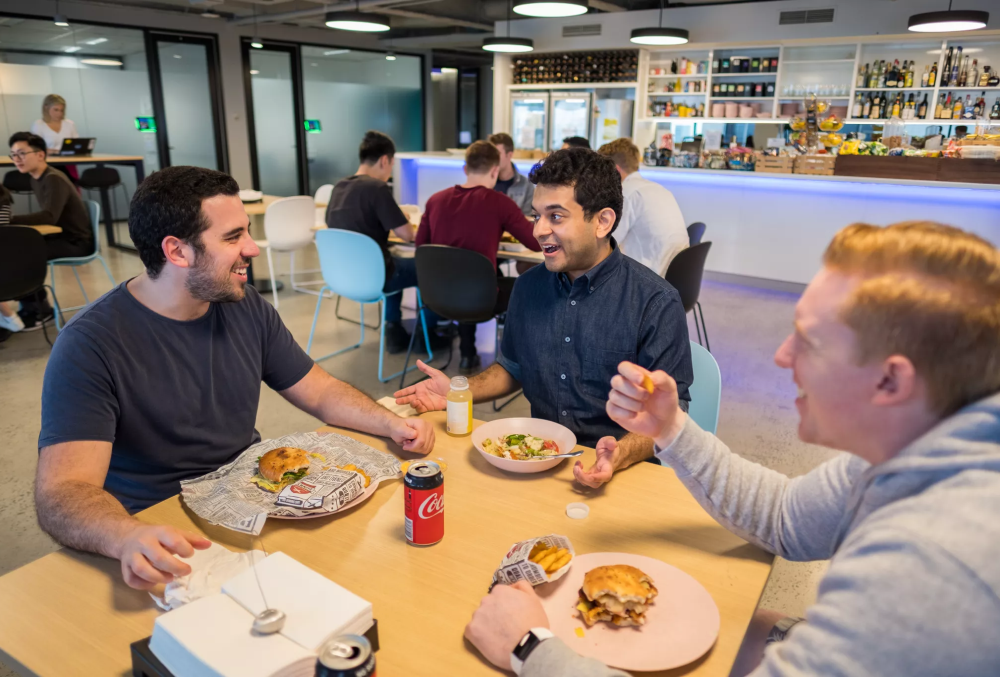 IMC Graduate- Male professional having lunch with colleagues.