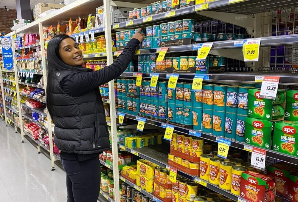Kraft Heinz Graduate- Young woman showing her products on the shelf.